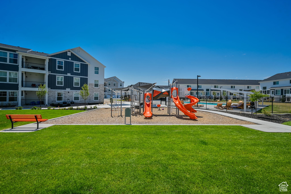 View of jungle gym featuring a lawn