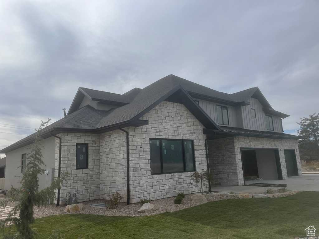 View of side of home featuring a lawn