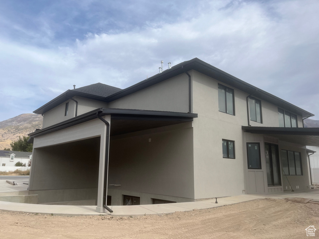 View of property exterior featuring a patio area and a mountain view