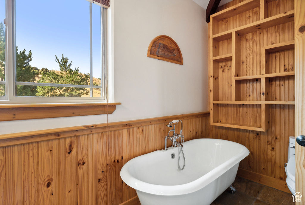 Bathroom with tile patterned flooring and a bathing tub