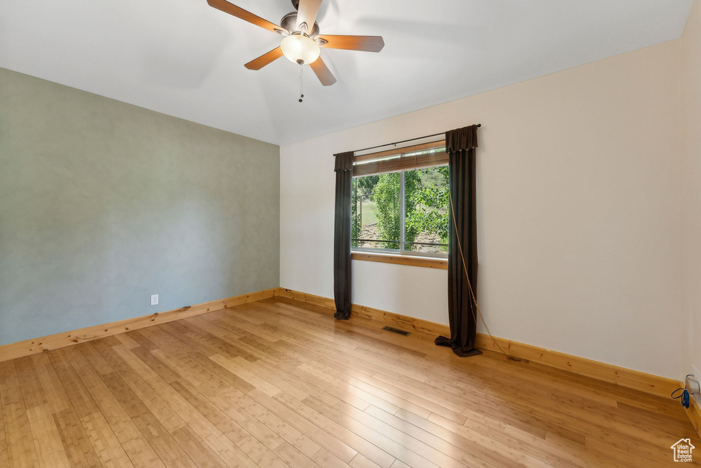 Spare room featuring light hardwood / wood-style floors and ceiling fan