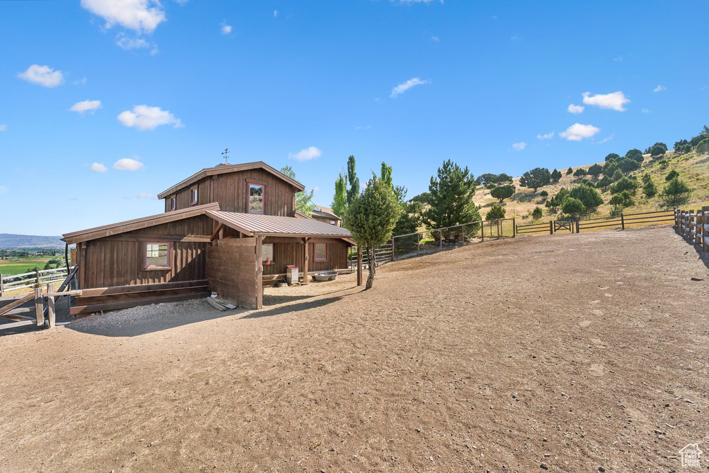 Back of property featuring a rural view