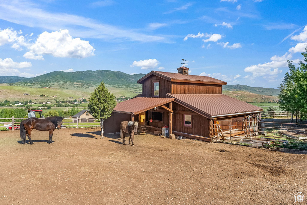 Exterior space with an outbuilding, a mountain view, and a rural view