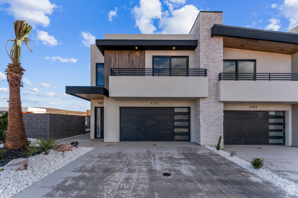 Contemporary home with a balcony and a garage