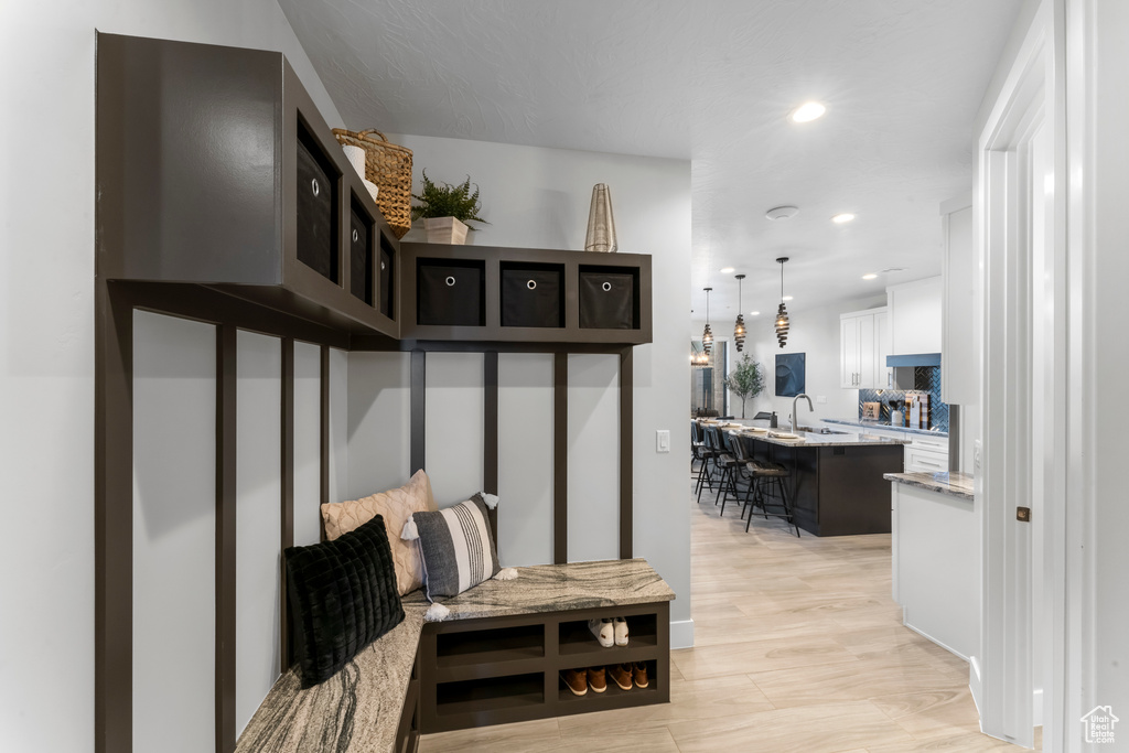 Mudroom with light hardwood / wood-style floors