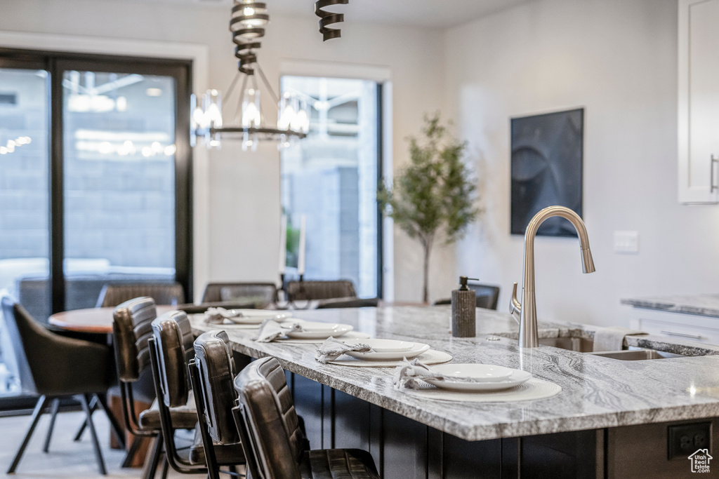 Dining area with a notable chandelier