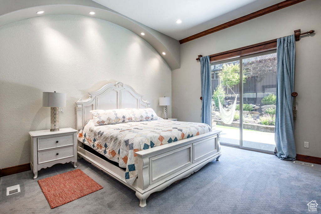 Bedroom with access to exterior, dark colored carpet, and ornamental molding