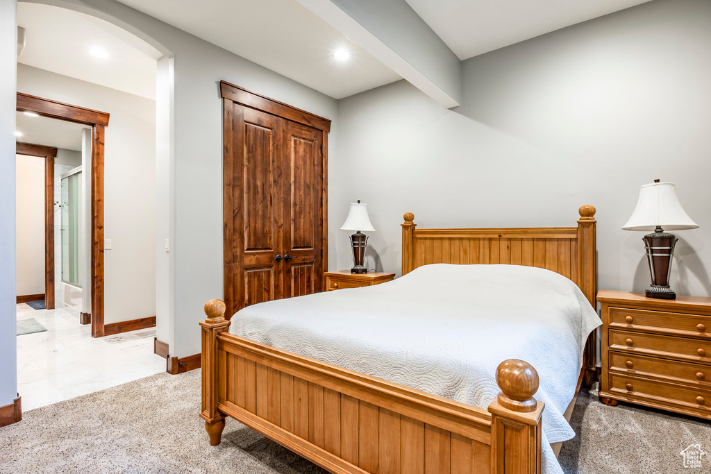 Bedroom with carpet and beam ceiling