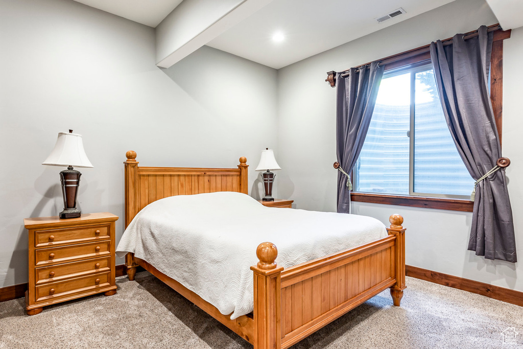 Carpeted bedroom with beamed ceiling