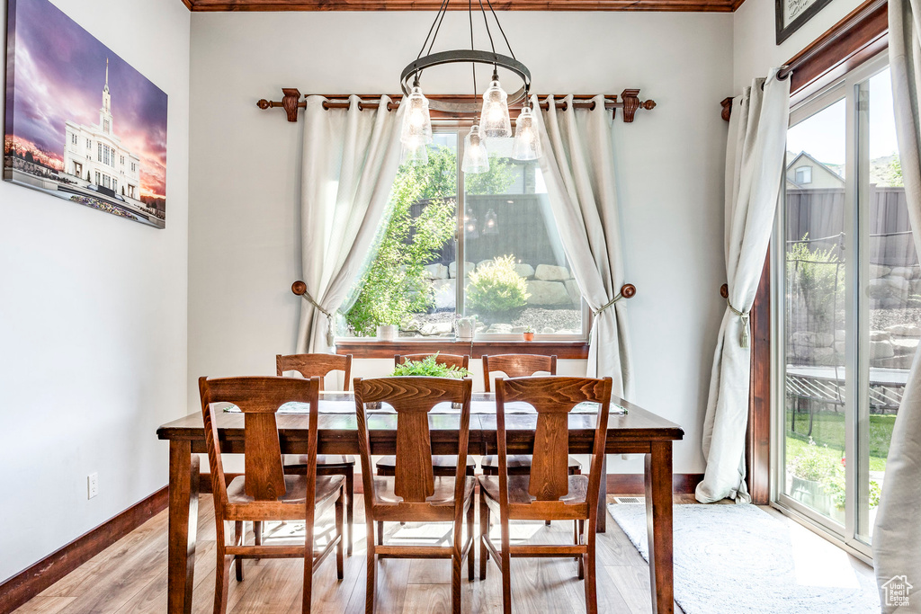 Dining area with hardwood / wood-style flooring and a chandelier