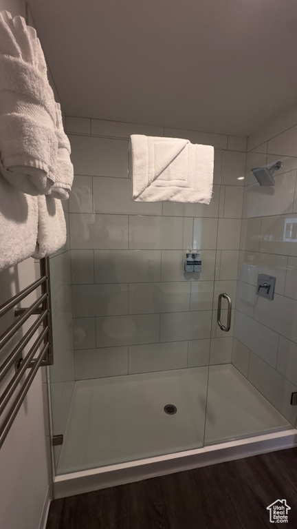 Bathroom featuring hardwood / wood-style flooring and walk in shower