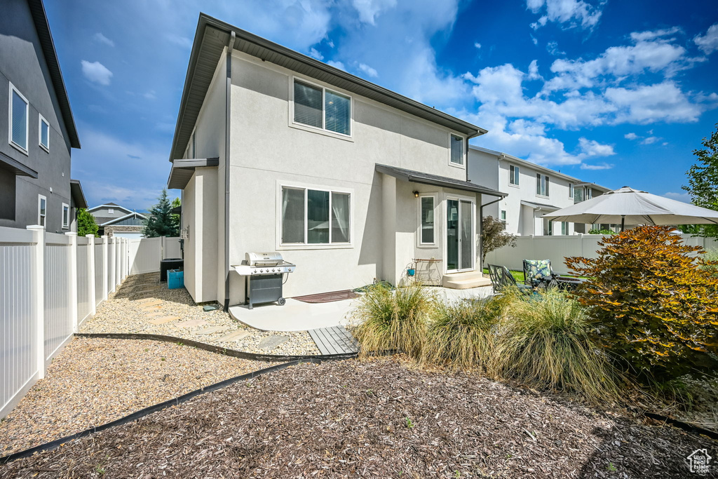 Rear view of house featuring a patio area