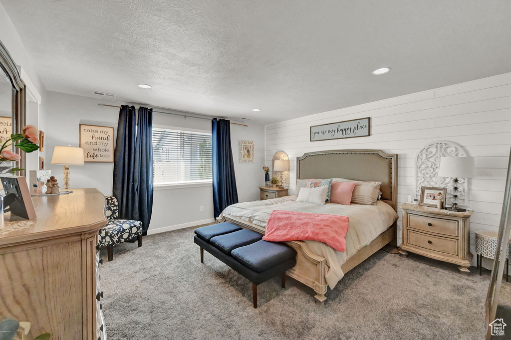 Carpeted bedroom featuring a textured ceiling