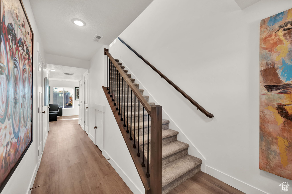 Staircase with hardwood / wood-style floors