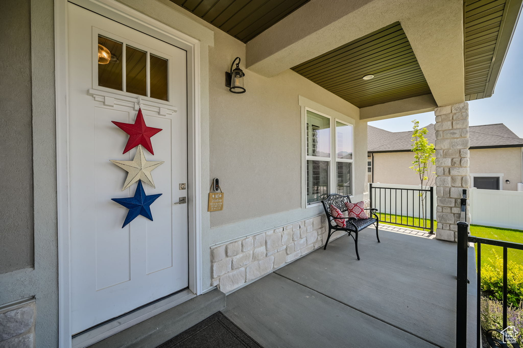 Doorway to property featuring a porch