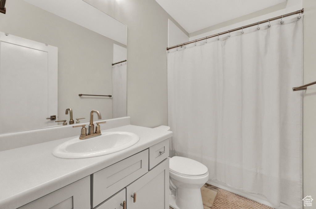 Bathroom featuring tile patterned floors, vanity, and toilet