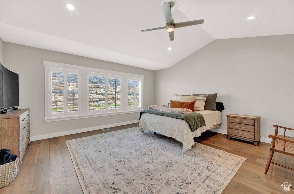 Bedroom featuring hardwood / wood-style flooring, lofted ceiling, and ceiling fan