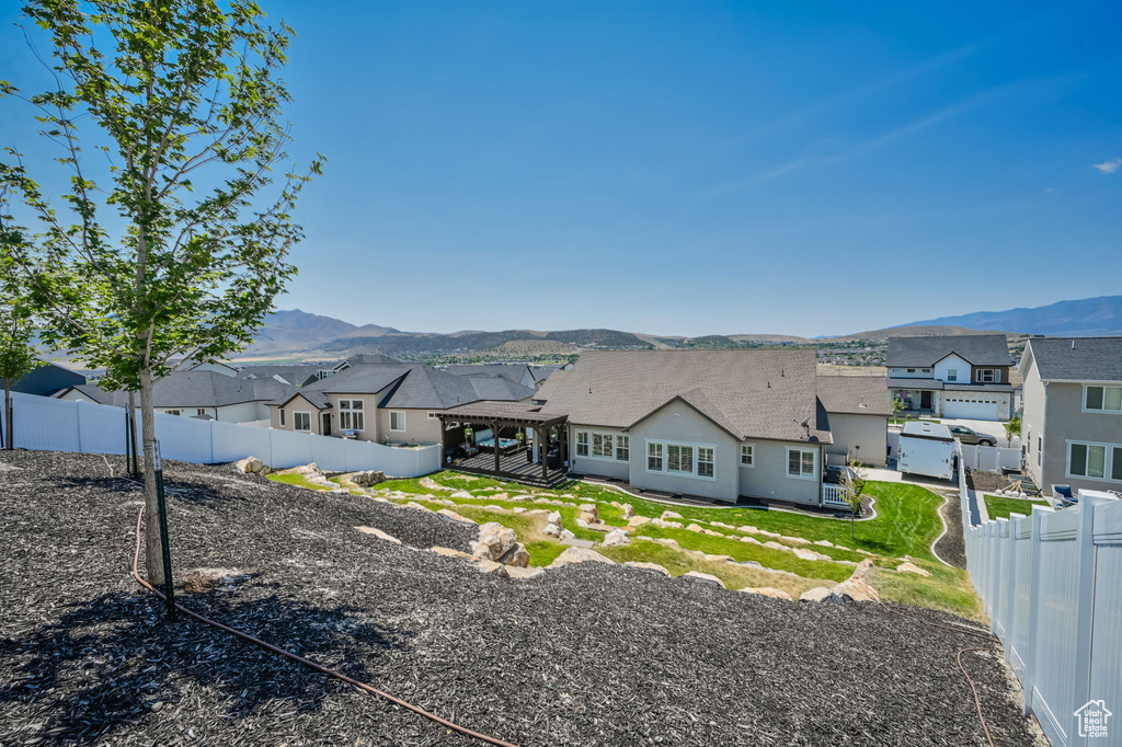 Rear view of property with a mountain view