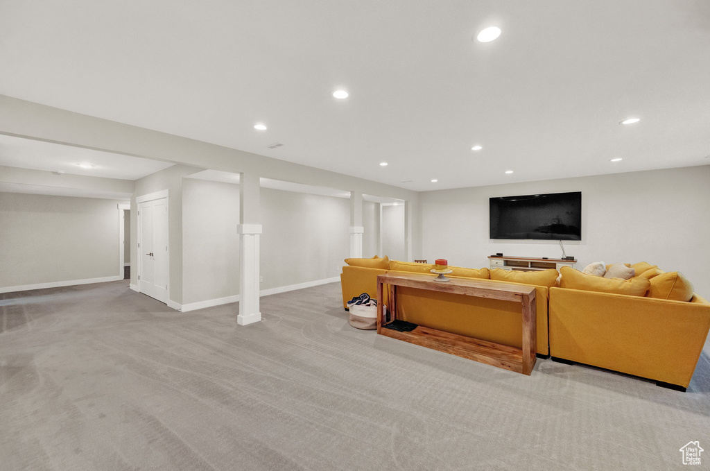 Living room with decorative columns and carpet flooring