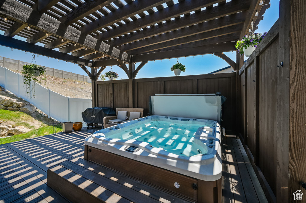 Exterior space featuring a pergola and a covered hot tub