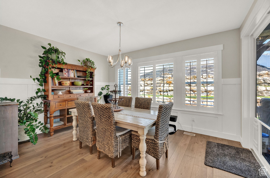 Dining area featuring an inviting chandelier and light hardwood / wood-style flooring