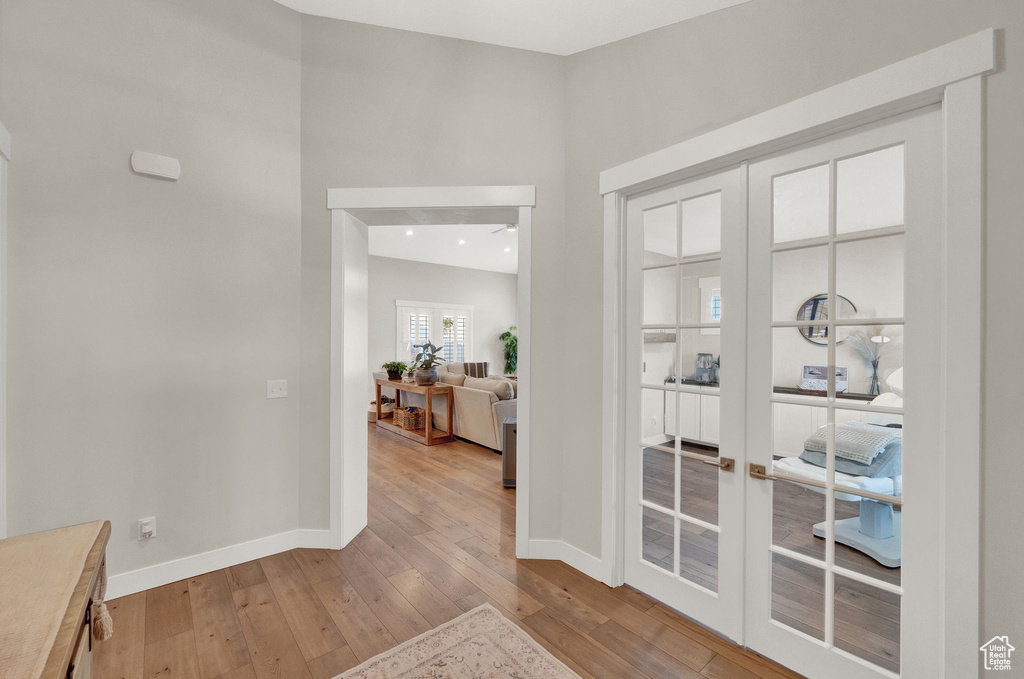 Hallway featuring french doors and hardwood / wood-style flooring