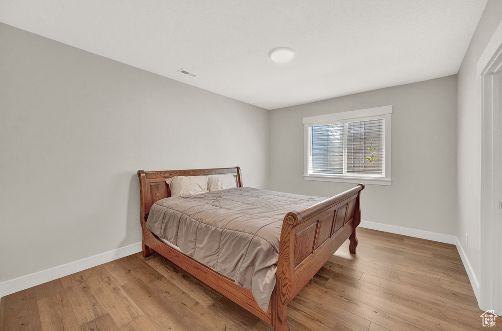 Bedroom with hardwood / wood-style flooring