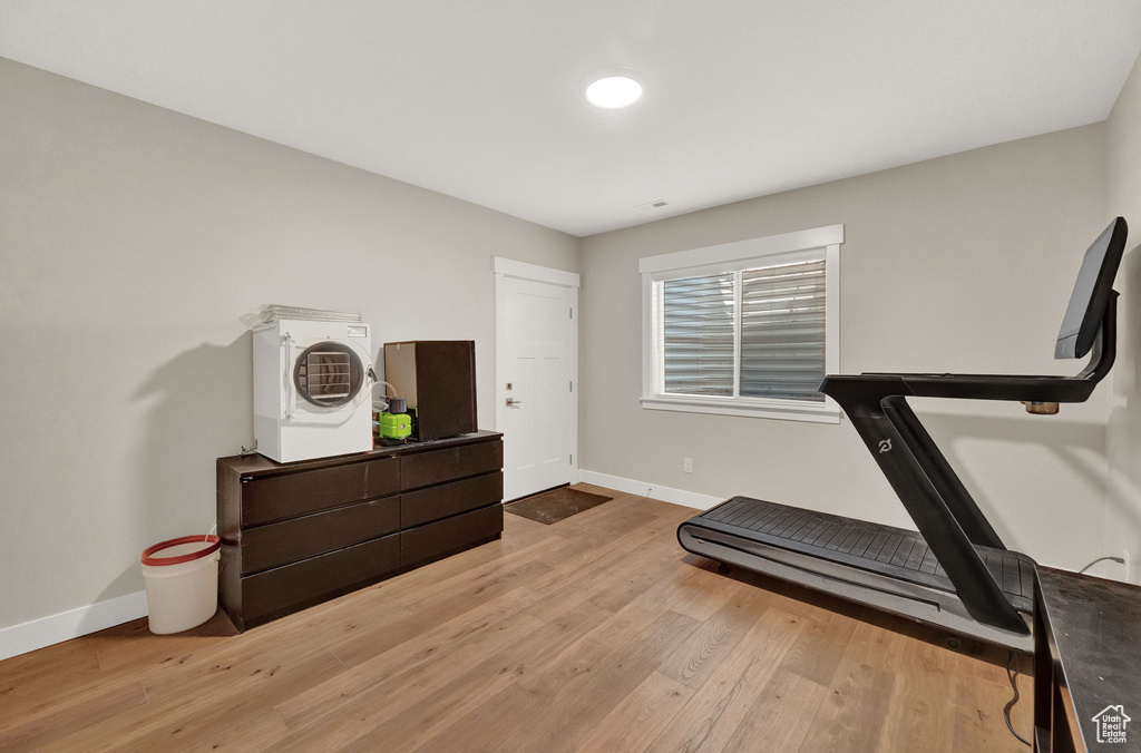 Exercise room with hardwood / wood-style flooring