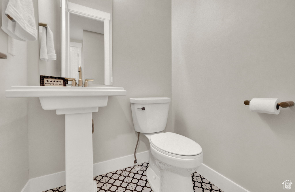 Bathroom featuring tile patterned flooring and toilet