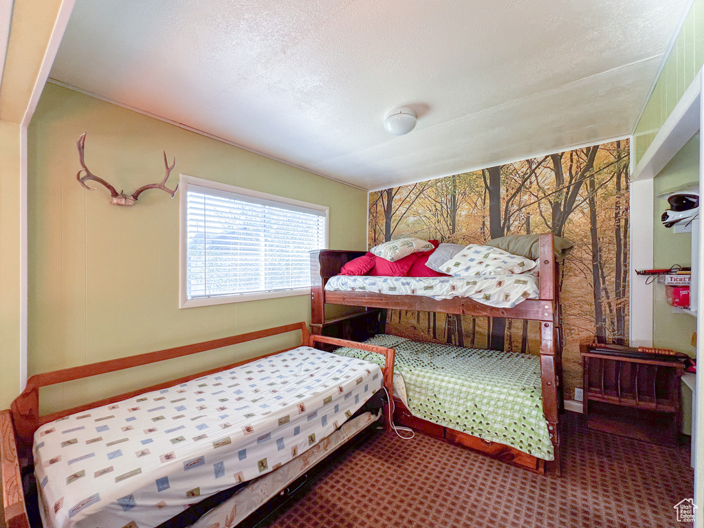 Bedroom with carpet floors and a textured ceiling