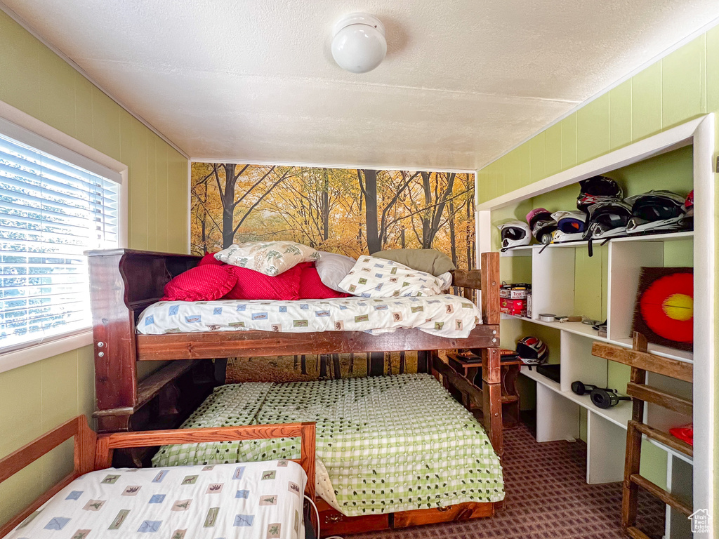 Bedroom featuring carpet and a textured ceiling