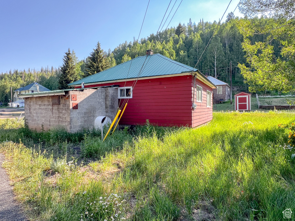 Rear view of property featuring a shed