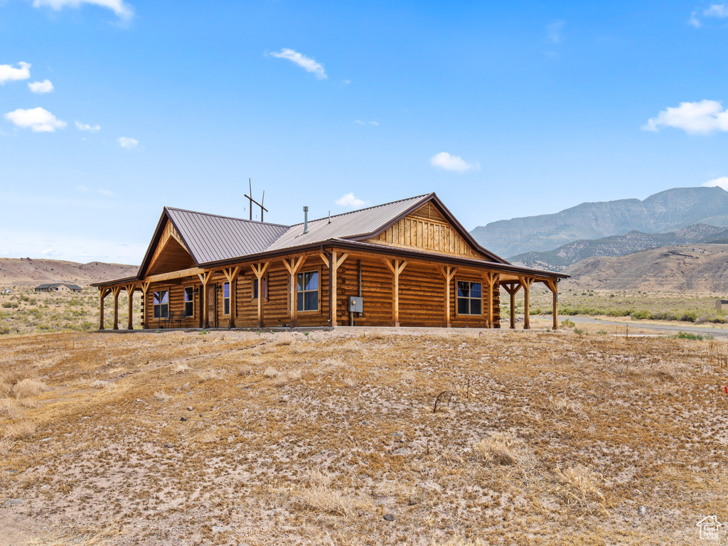 Log home featuring covered porch