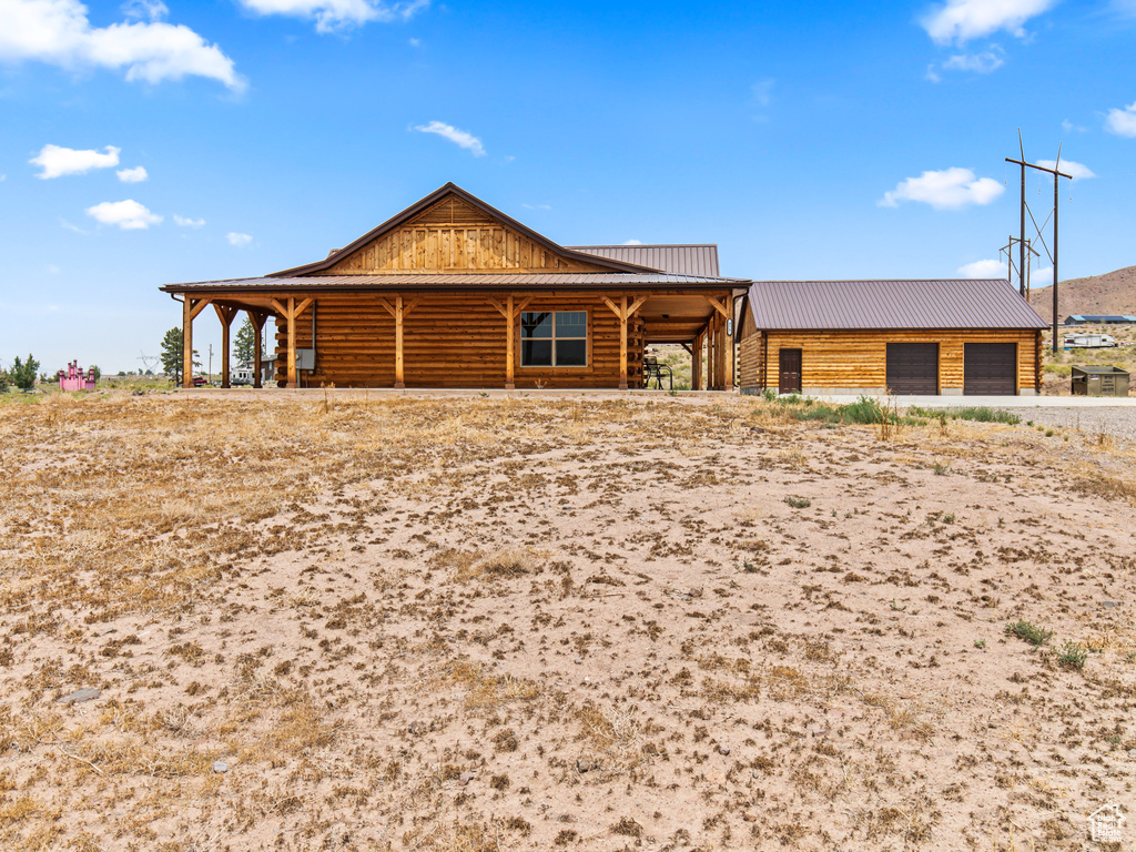 View of front of house with an outdoor structure and a garage