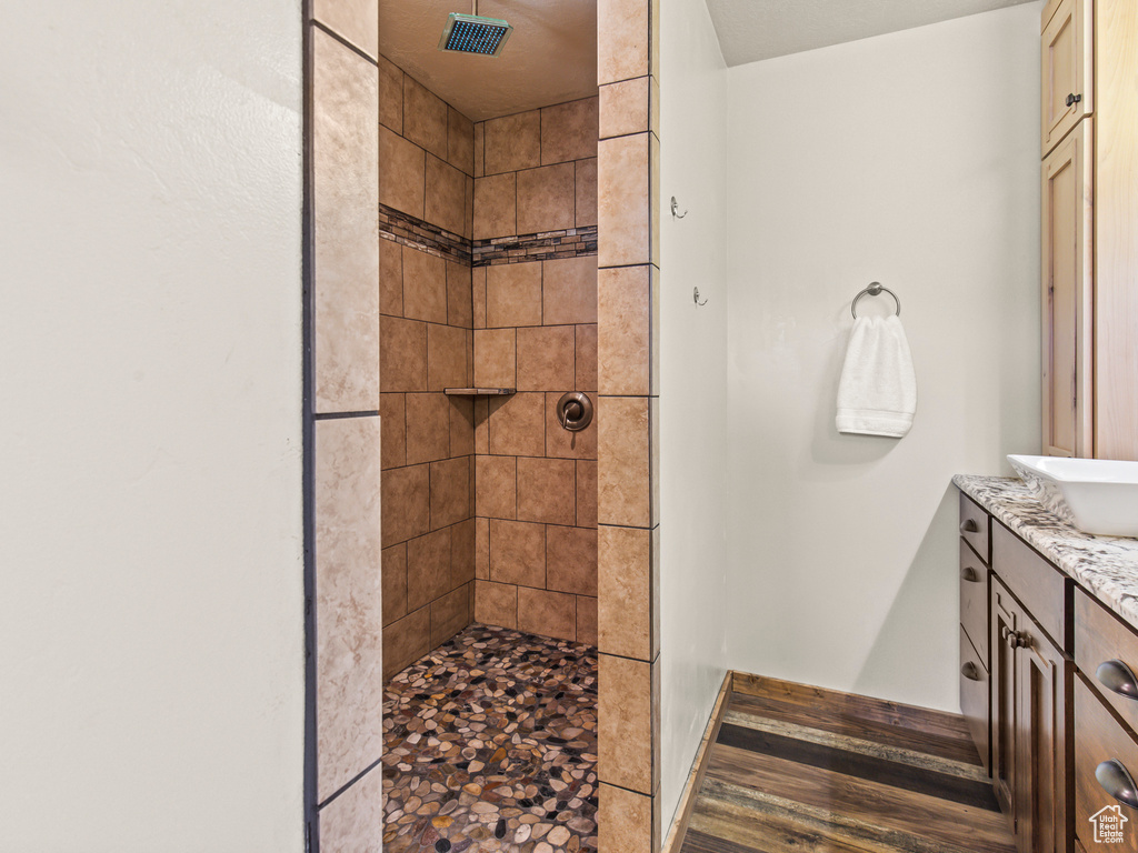 Bathroom with vanity and a tile shower