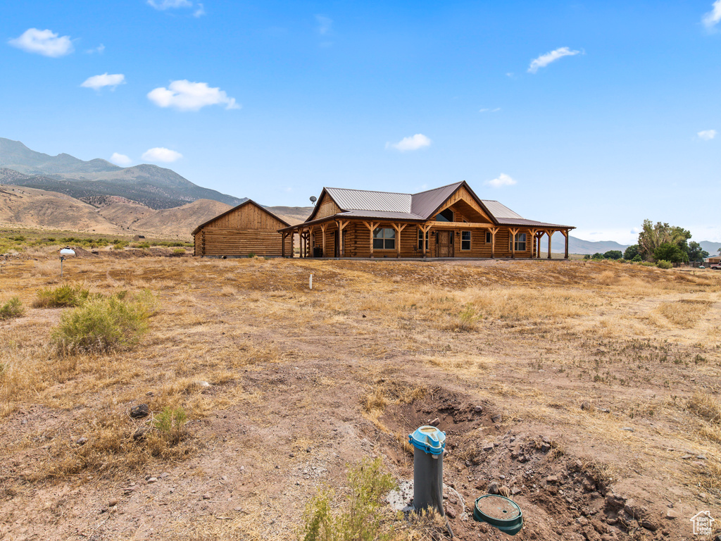 View of front of property featuring a mountain view and a rural view