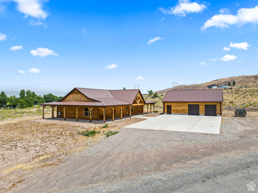 Cabin with a garage and an outbuilding