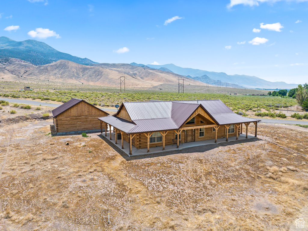 View of front facade with a mountain view and an outdoor structure