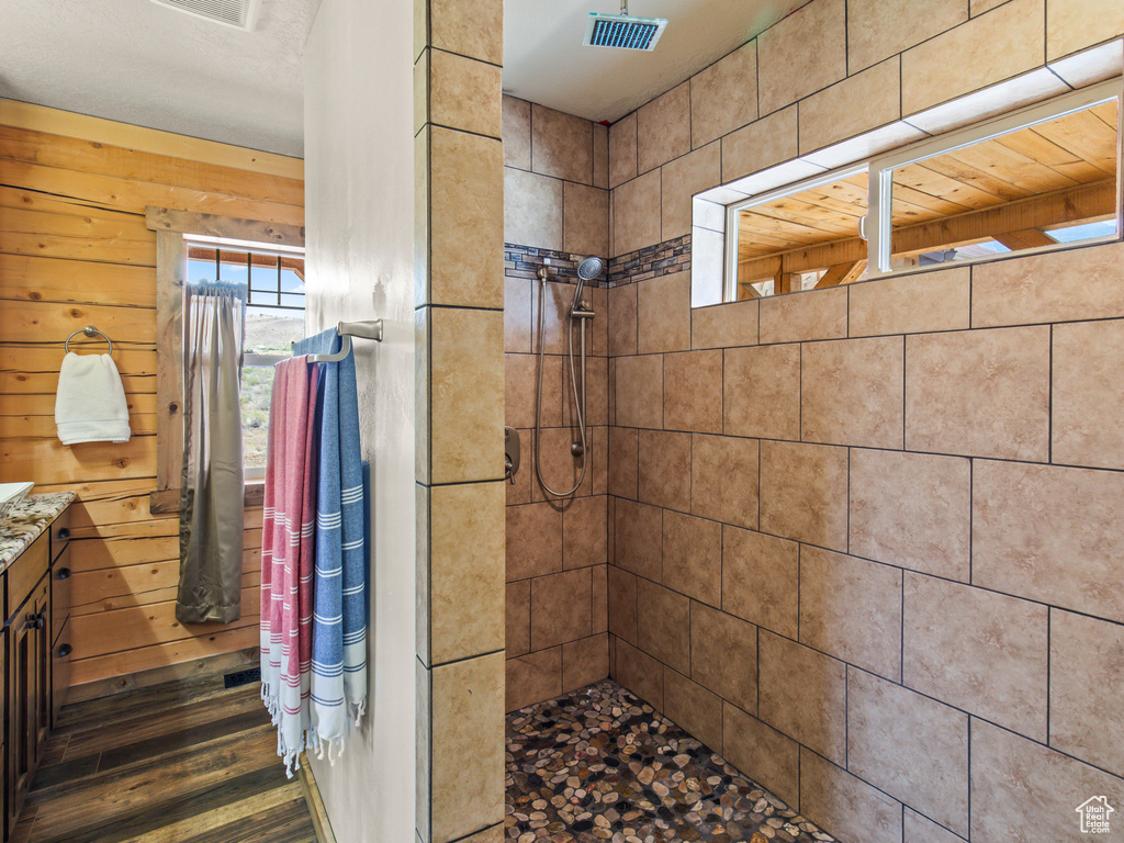 Bathroom with hardwood / wood-style flooring, a shower with curtain, and vanity