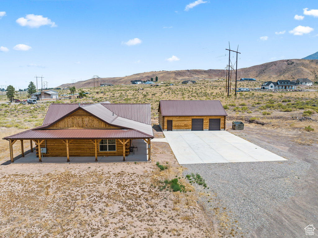 View of front facade with a mountain view and an outdoor structure