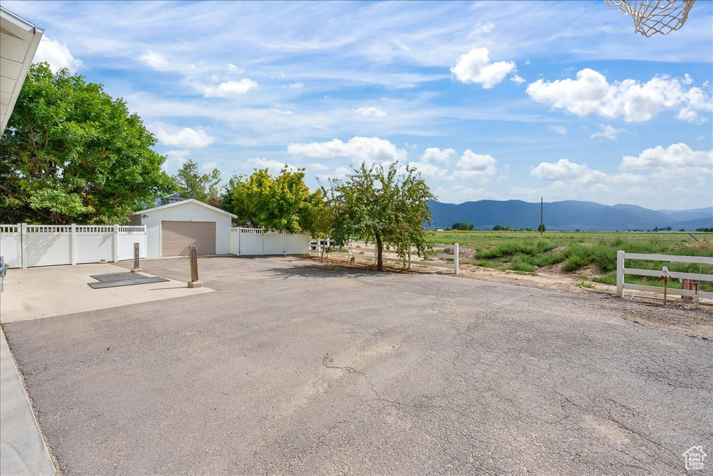 Exterior space featuring a garage, an outbuilding, and a mountain view