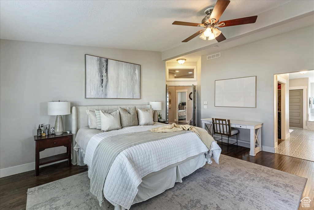 Bedroom with ceiling fan and dark hardwood / wood-style floors