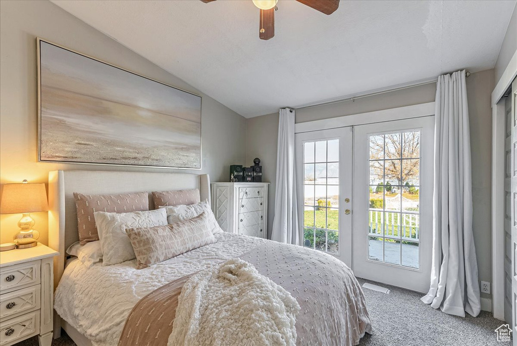 Carpeted bedroom with access to outside, french doors, ceiling fan, and lofted ceiling