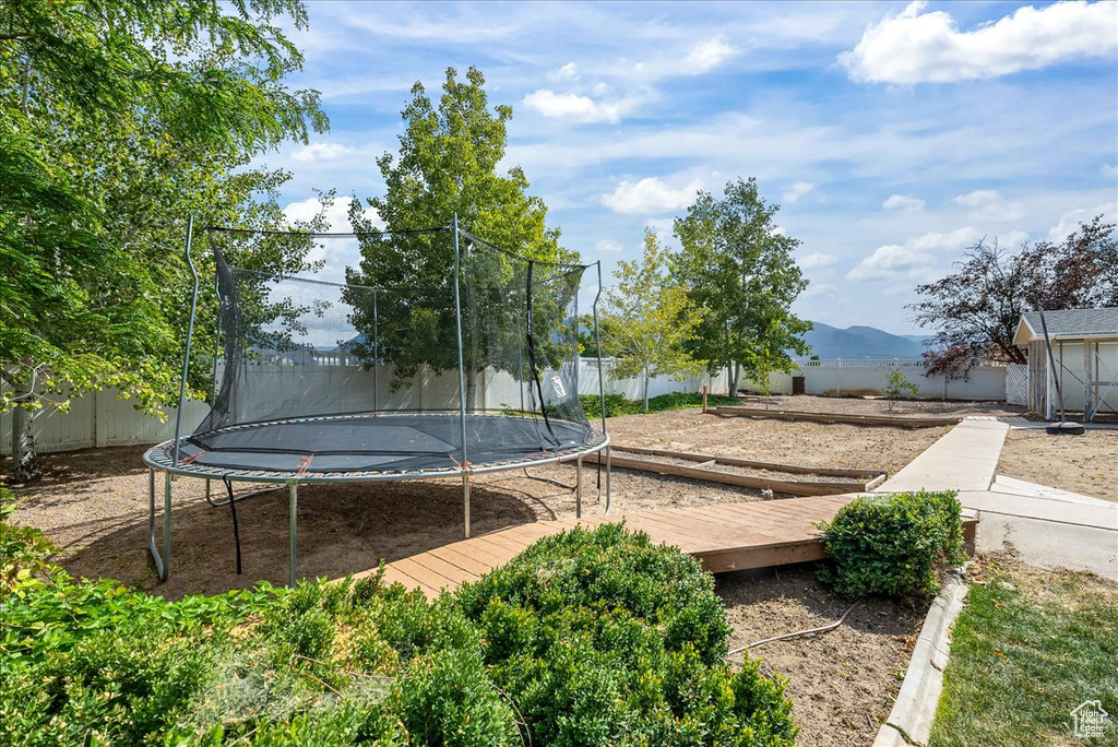 View of yard with a mountain view and a trampoline