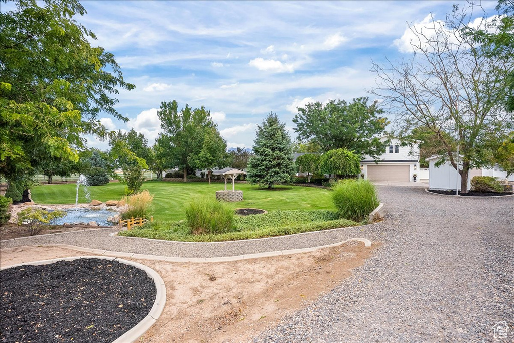 Exterior space with a garage and a lawn