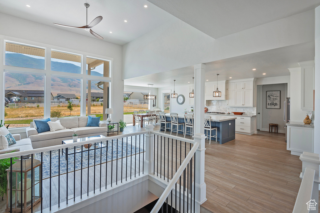 Living room featuring light hardwood / wood-style flooring and ceiling fan