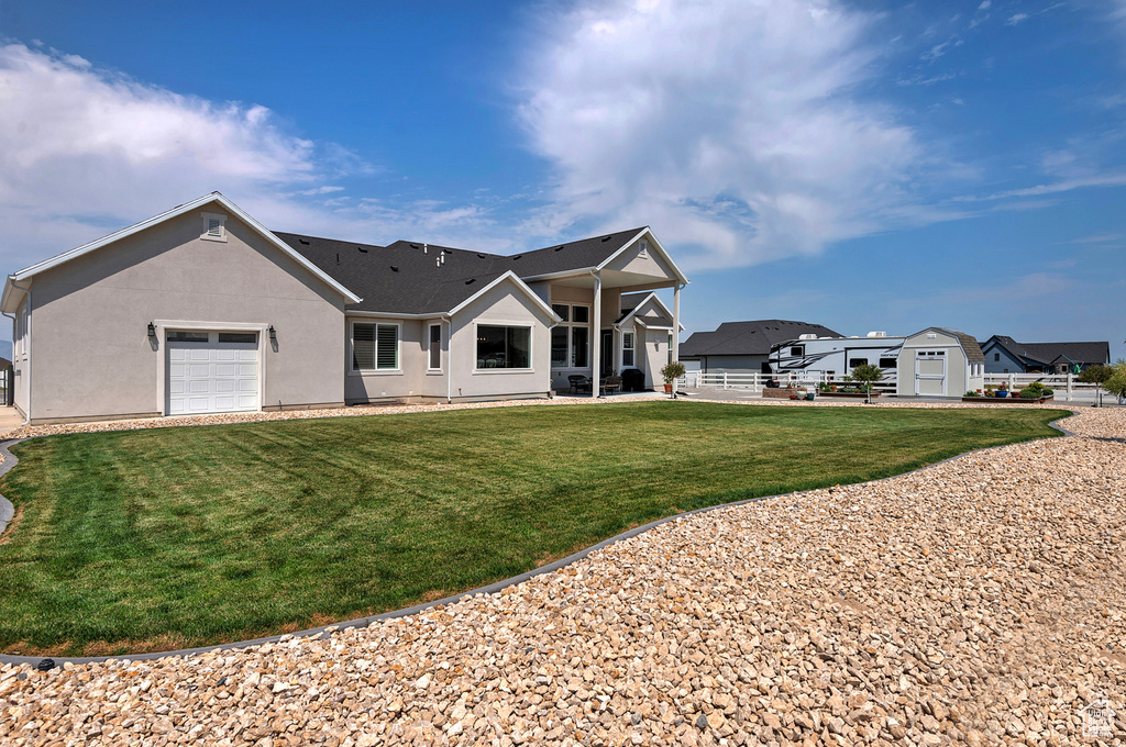 View of front of home featuring a garage and a front yard