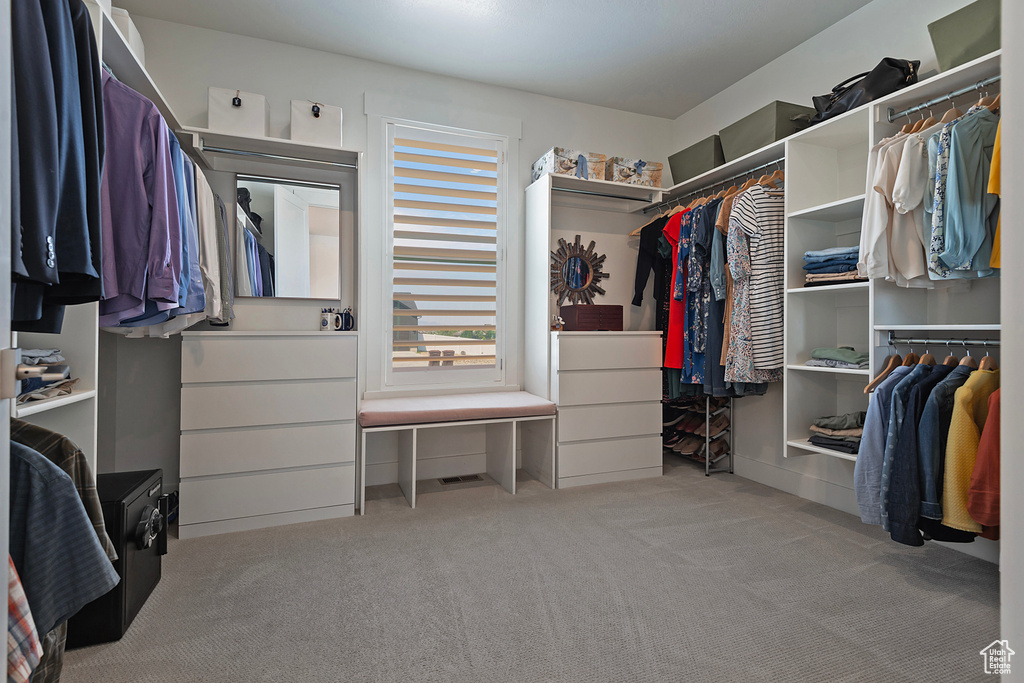 Walk in closet featuring light carpet