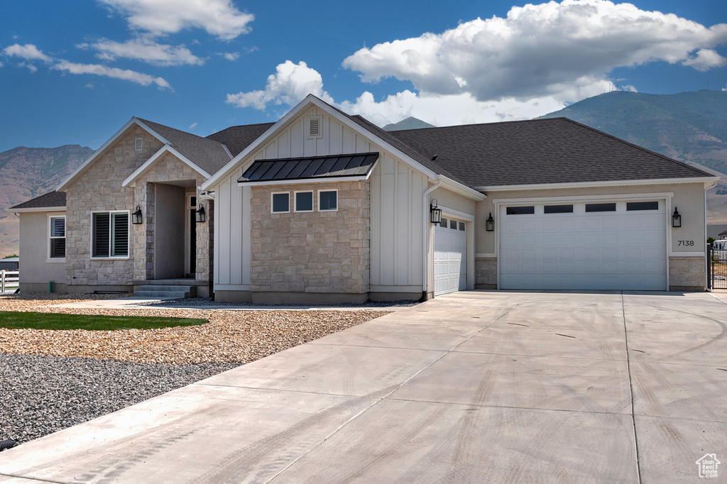 View of front of property featuring a mountain view and a garage