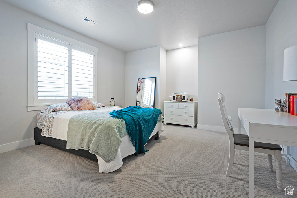 Bedroom featuring light colored carpet